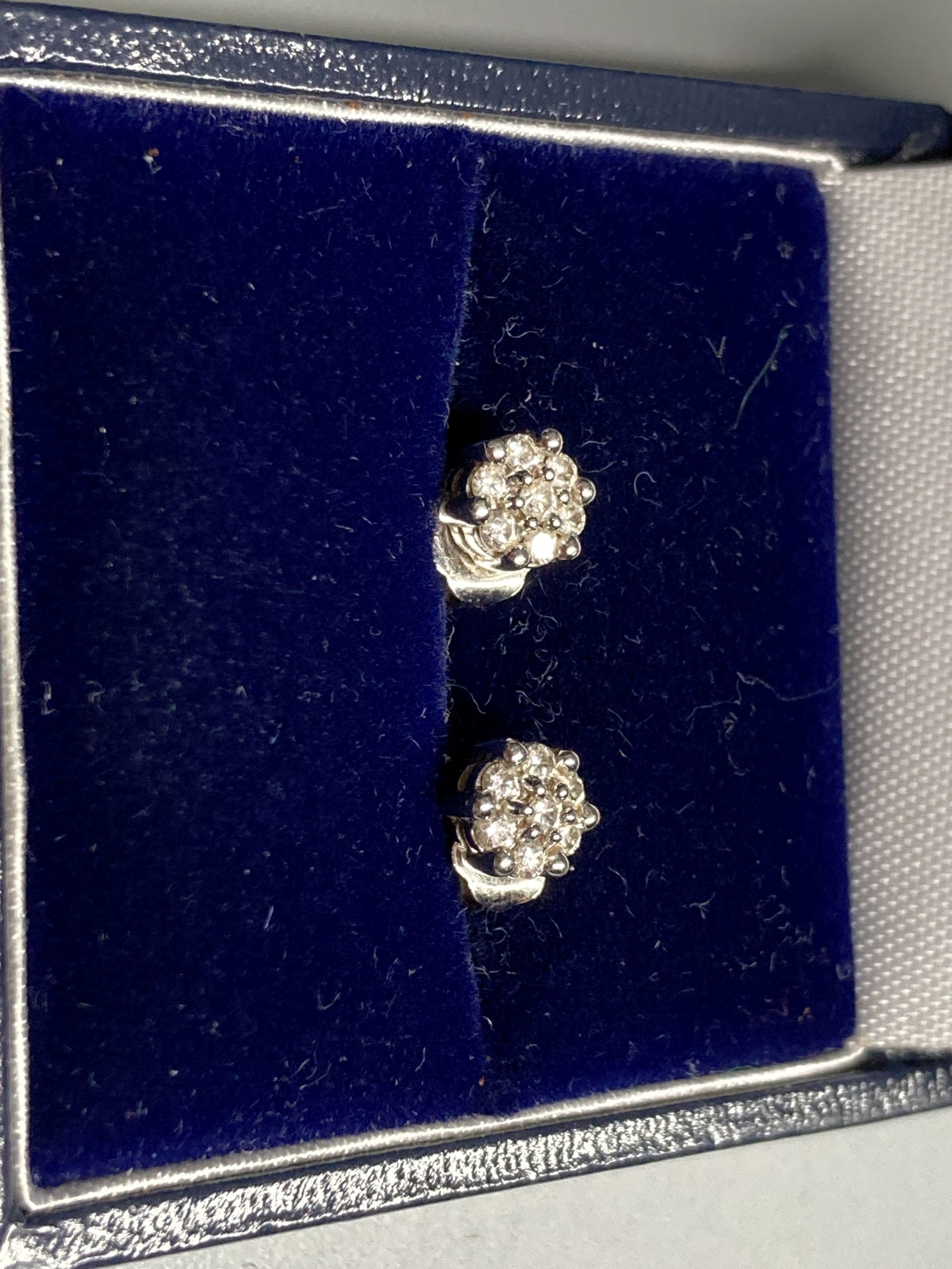 A pair of modern white metal (stamped 750) and small seven stone diamond cluster ear studs, 5mm, gross 1.6 grams.